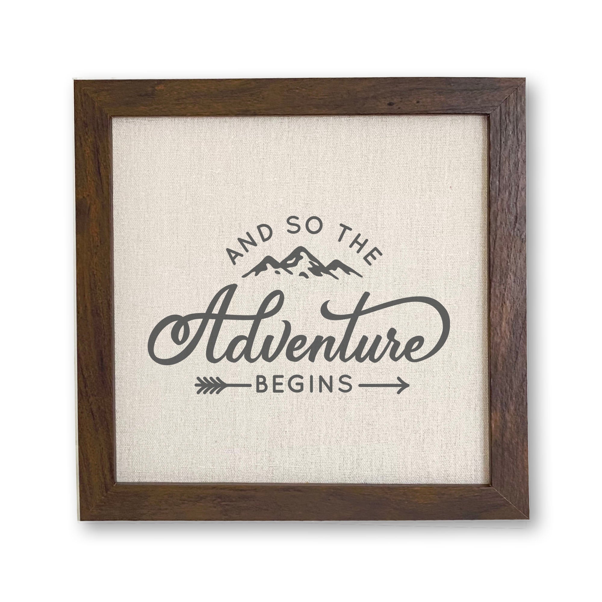 Framed sign reading 'And so the Adventure Begins' with a stylish wood frame and linen-look background.