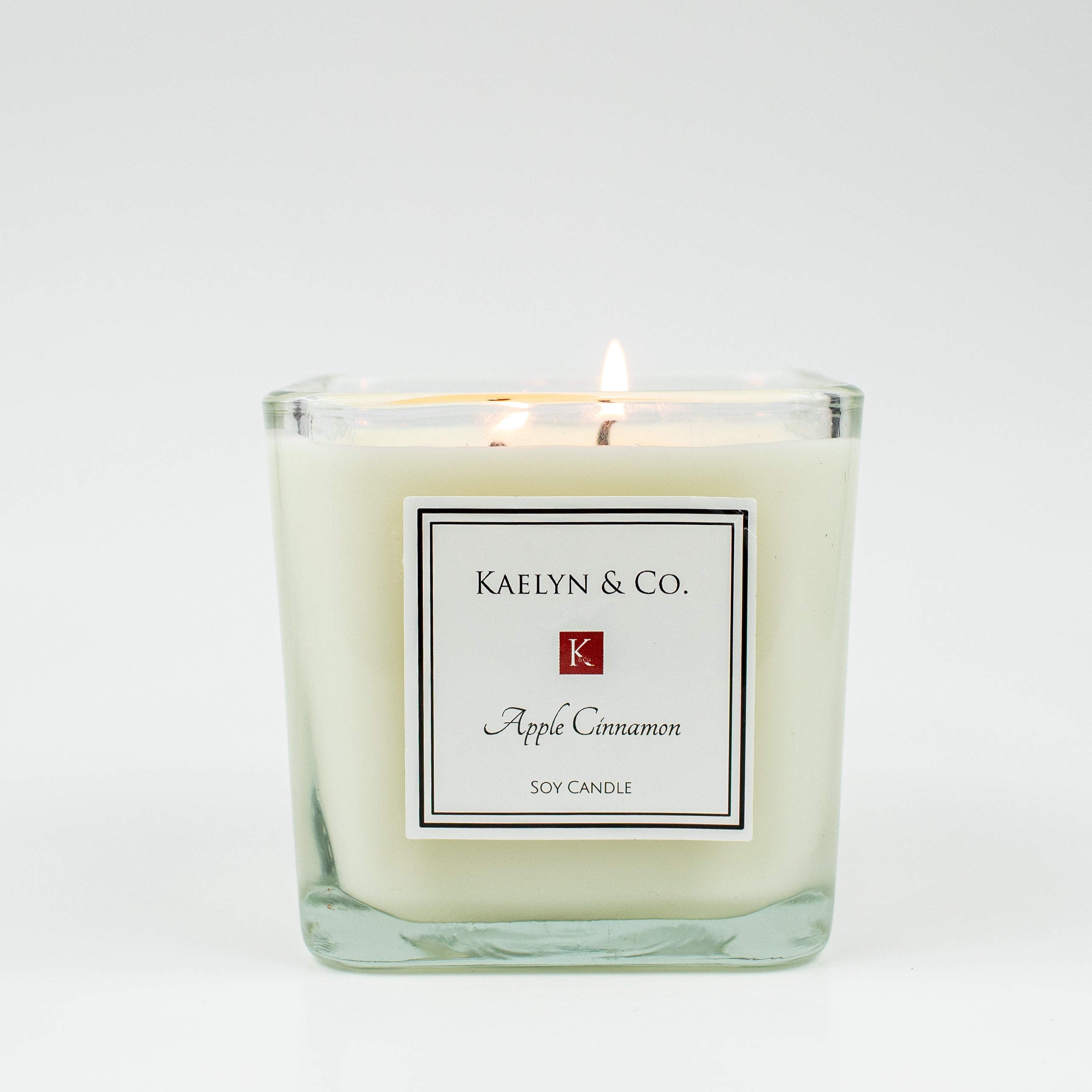 Apple Cinnamon Medium Cube Candle in elegant cube shape, showcasing its warm color and double wick design, perfect for cozy atmospheres.