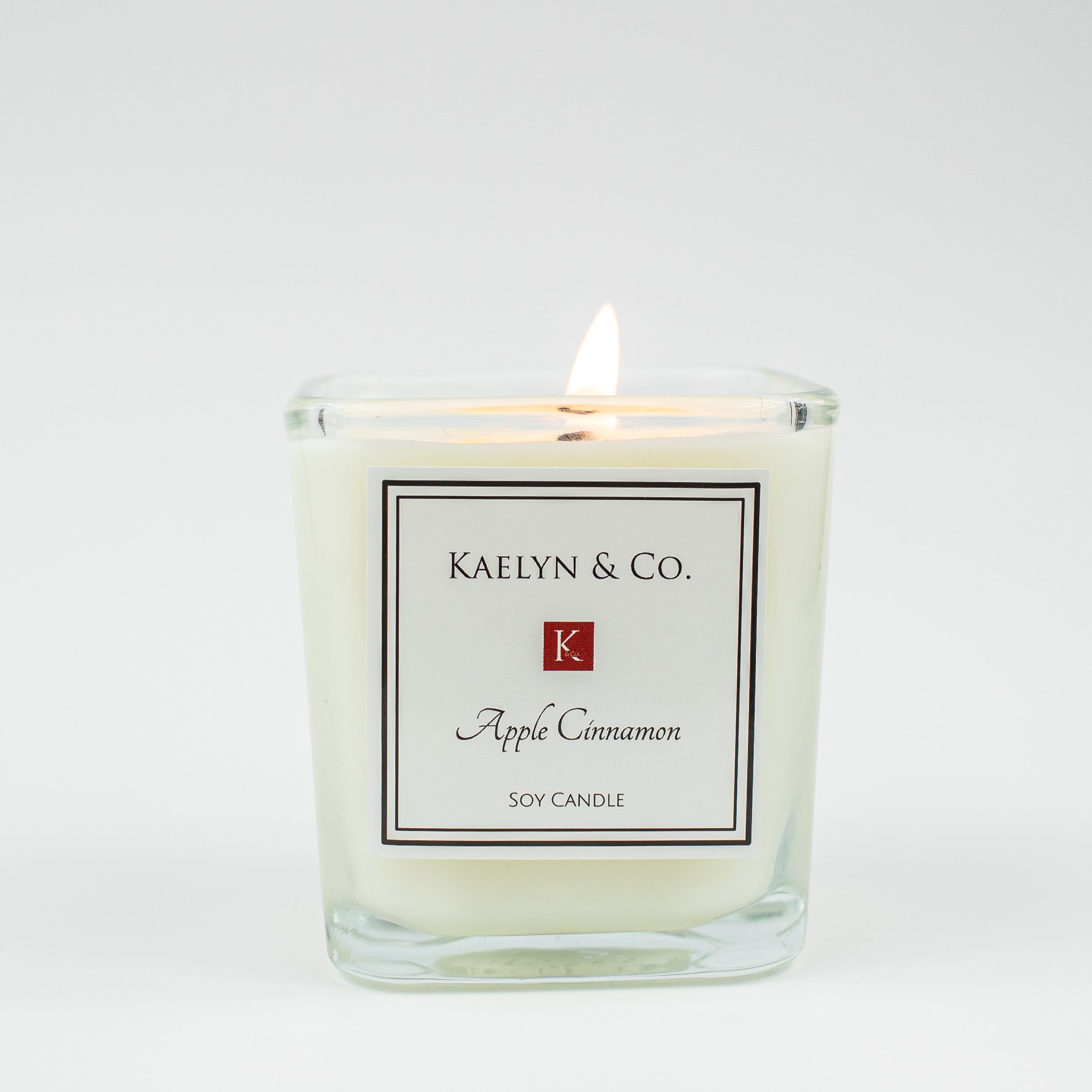 Apple Cinnamon Small Cube Candle in a stylish design, showcasing its warm color and inviting aroma.
