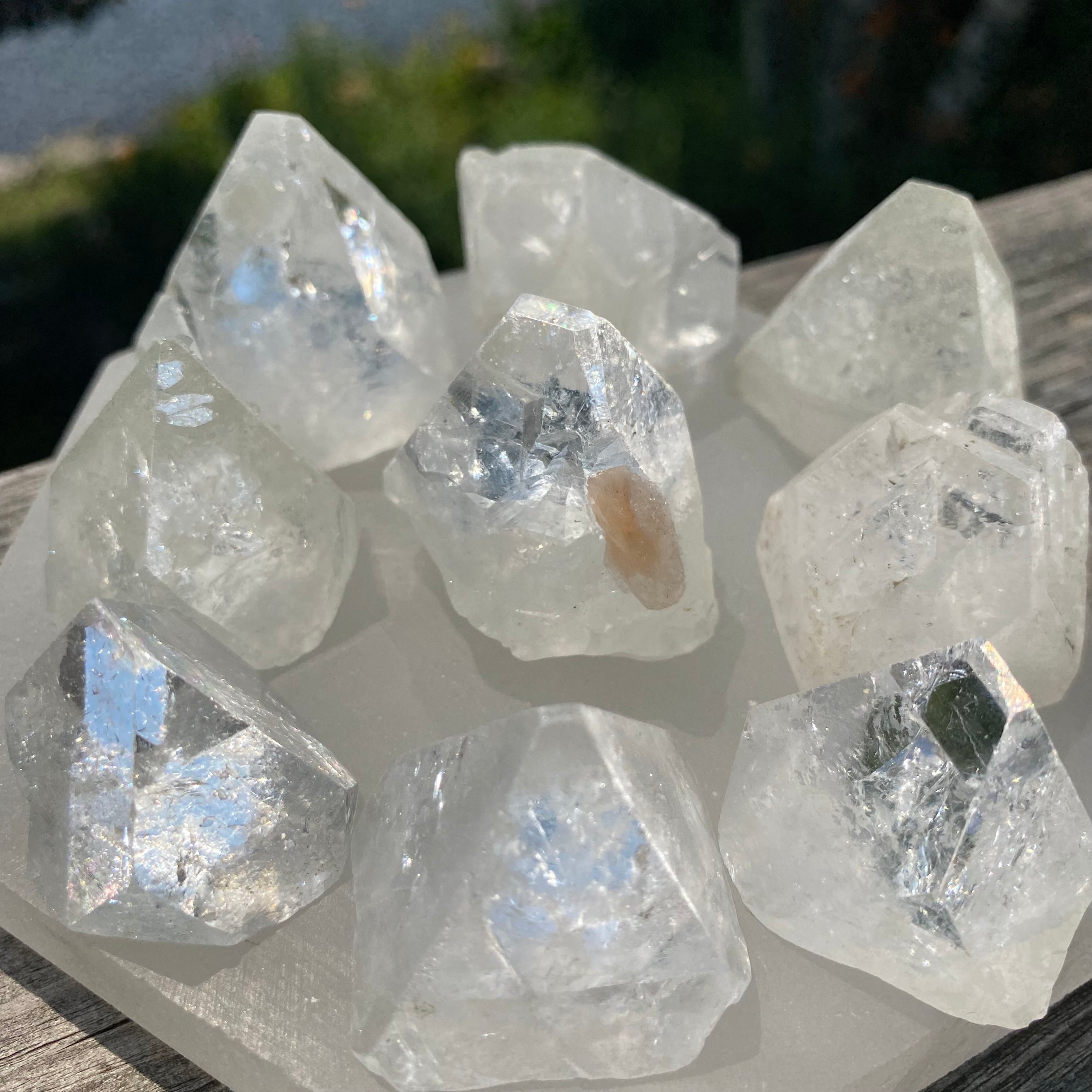 A collection of iridescent Apophyllite Polished Tips showcasing unique shapes and reflective surfaces.