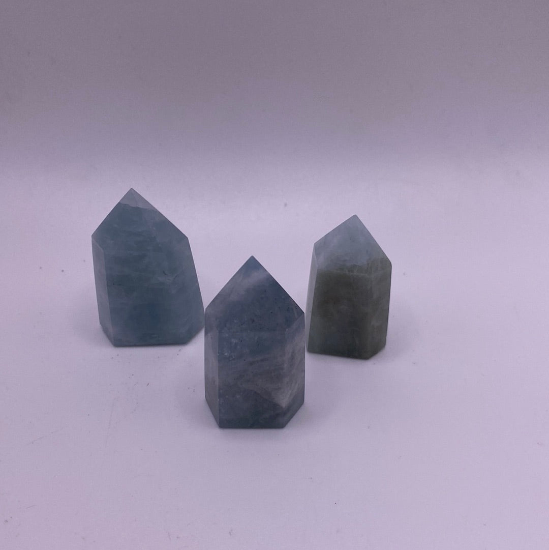 Aquamarine 1” Polished Point showcasing light blue and green hues with a smooth surface and pyramidal termination.