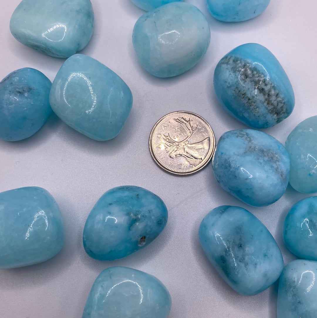 A beautiful Blue Aragonite Tumbled Stone showcasing calming blue and white swirls, perfect for crystal collectors and metaphysical enthusiasts.