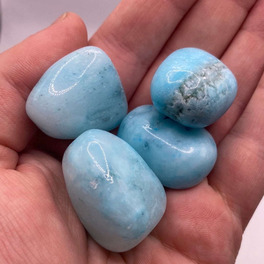 A beautiful Blue Aragonite Tumbled Stone showcasing calming blue and white swirls, perfect for crystal collectors and metaphysical enthusiasts.