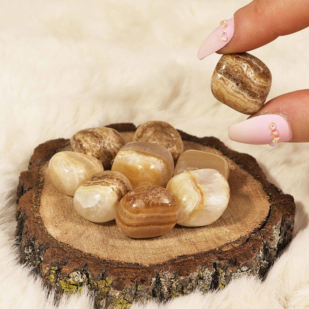 A collection of smooth, polished Aragonite Tumbled Stones showcasing their natural earthy colors and textures, ideal for grounding and healing.