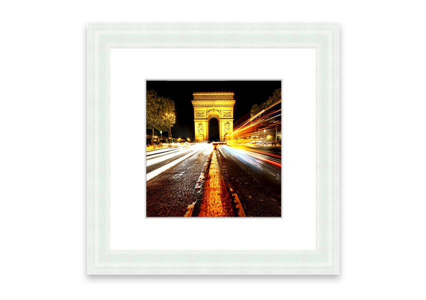 Framed print of the Arc De Triomphe illuminated at night, showcasing its architectural beauty.