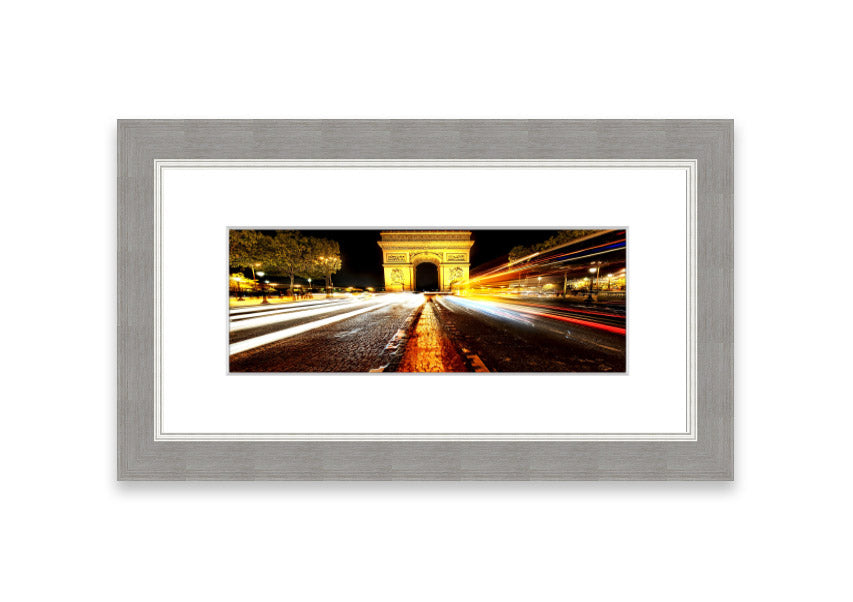 Framed print of the Arc De Triomphe illuminated at night, showcasing its architectural beauty.
