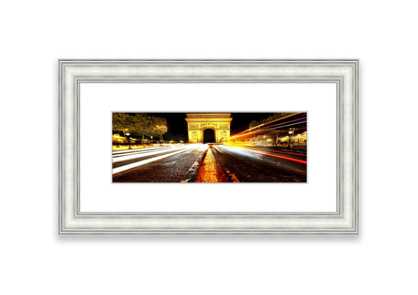 Framed print of the Arc De Triomphe illuminated at night, showcasing its architectural beauty.