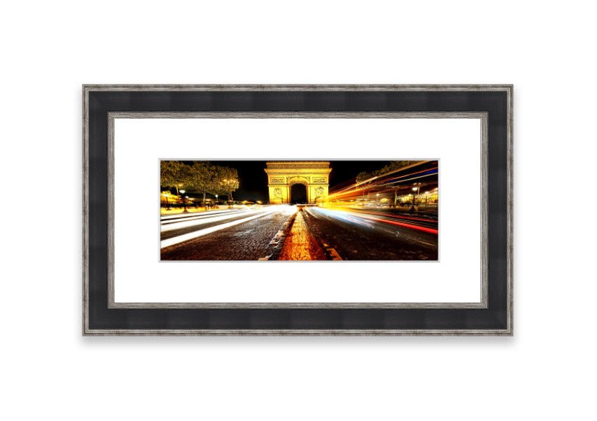 Framed print of the Arc De Triomphe illuminated at night, showcasing its architectural beauty.
