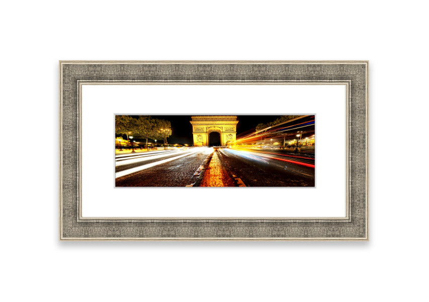 Framed print of the Arc De Triomphe illuminated at night, showcasing its architectural beauty.