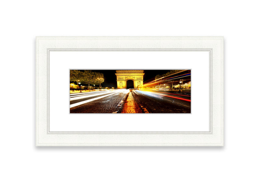 Framed print of the Arc De Triomphe illuminated at night, showcasing its architectural beauty.