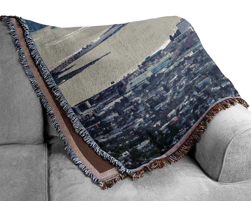 Ariel View Of The City throw blanket made from 100% cotton, featuring a thermal weave for breathability and a luxurious finish, draped elegantly on a couch.