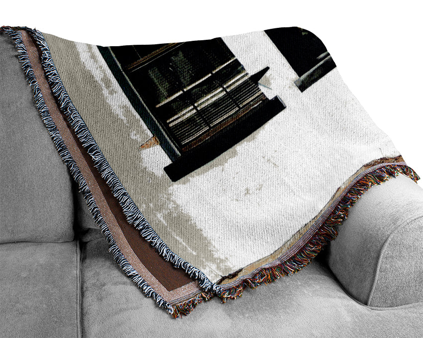 A luxurious Army Heist throw blanket made from 100% cotton, featuring a thermal weave design, draped elegantly over a couch.