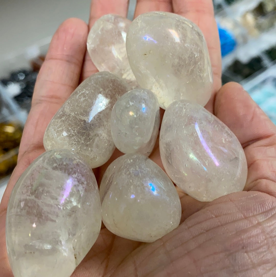 Aura Quartz Tumbled Stone (M) showcasing its iridescent colors and smooth surface, radiating positive energy.