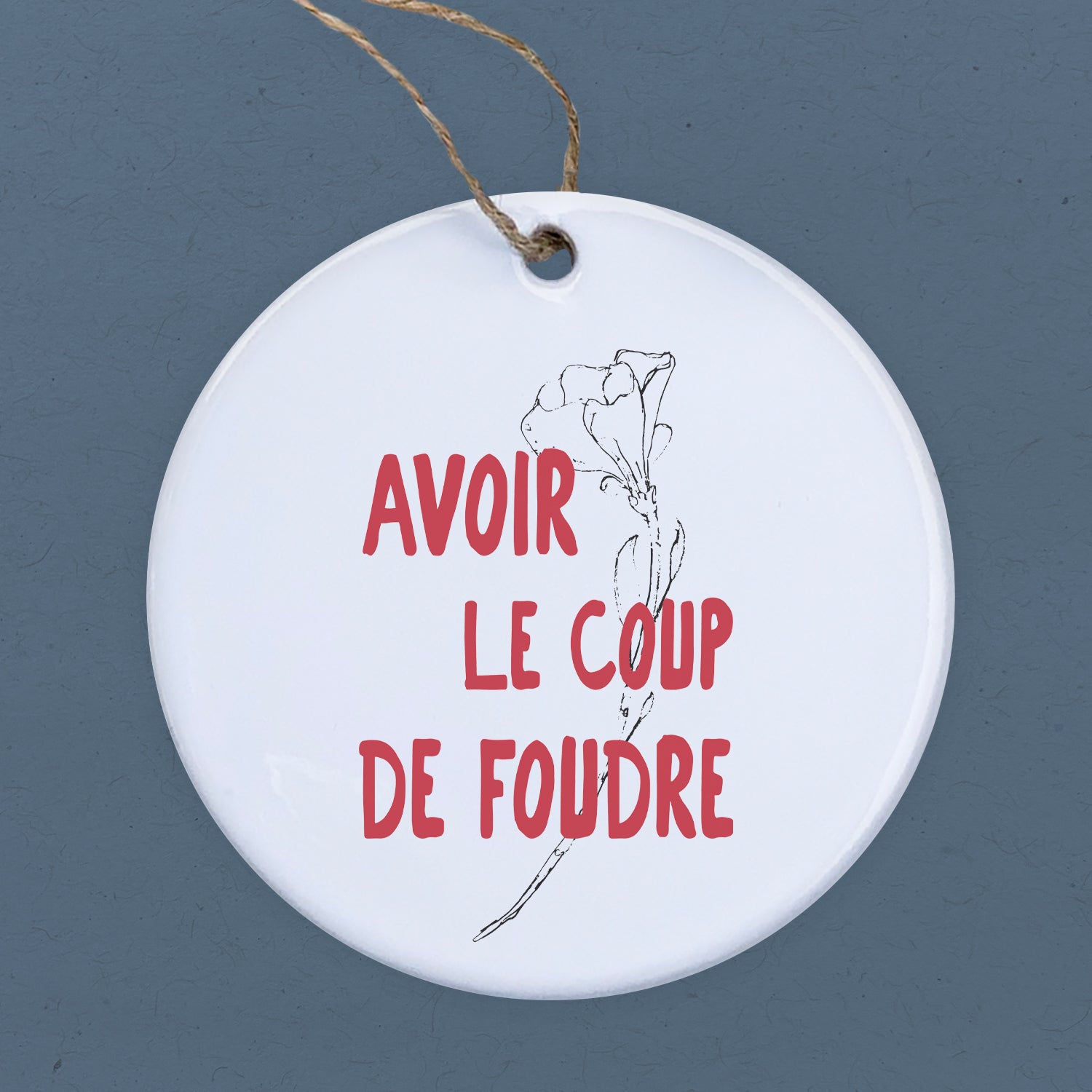 A beautiful porcelain ornament featuring the design 'Avoir le Coup de Foudre', showcasing vibrant colors and a glossy finish.