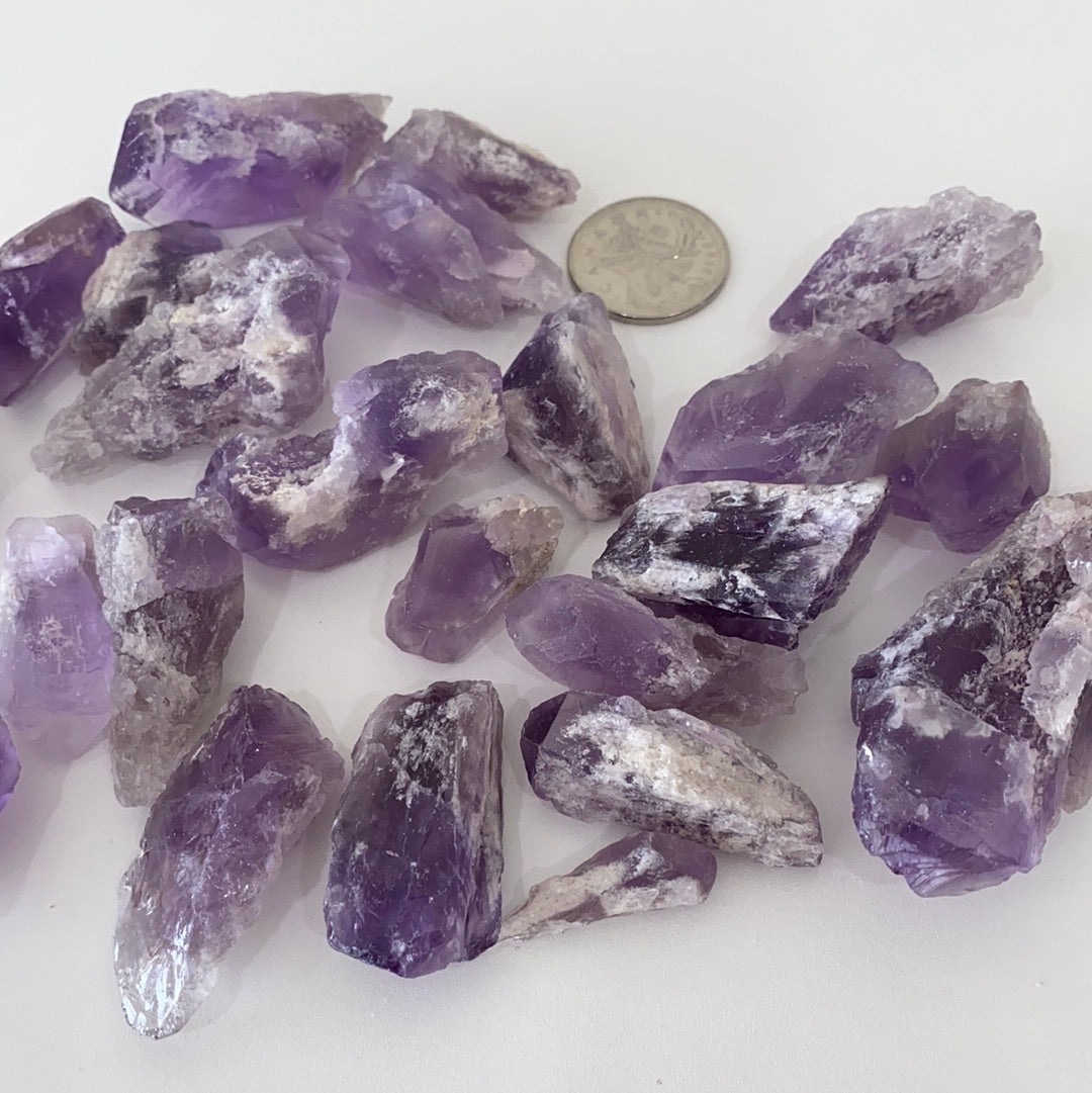 A collection of Bahia Amethyst Points, showcasing their unique purple hues and natural formations, each approximately 1.5-2 inches long.