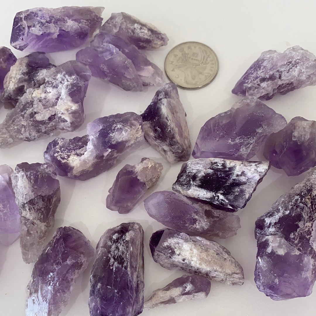 A collection of Bahia Amethyst Points, showcasing their unique purple hues and natural formations, each approximately 1.5-2 inches long.
