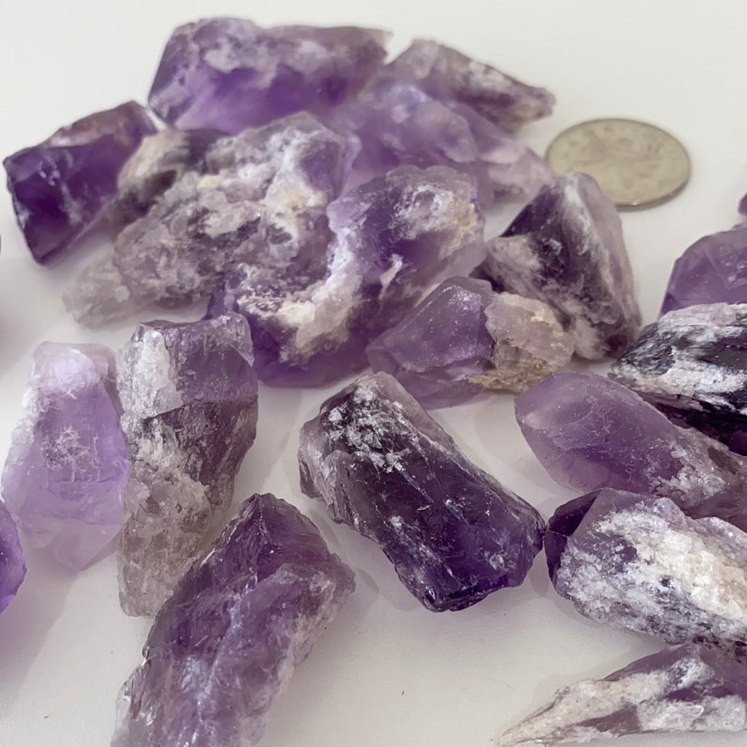 A collection of Bahia Amethyst Points, showcasing their unique purple hues and natural formations, each approximately 1.5-2 inches long.