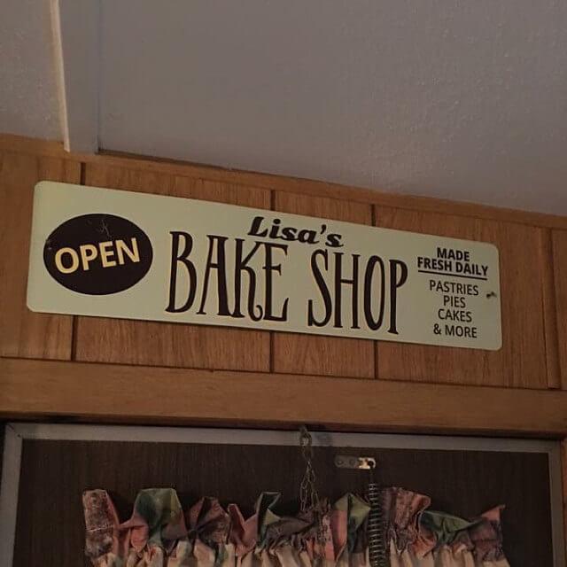 A decorative Bake Shop Open Sign made of high-quality aluminum, featuring customizable text and pre-drilled holes for easy mounting.