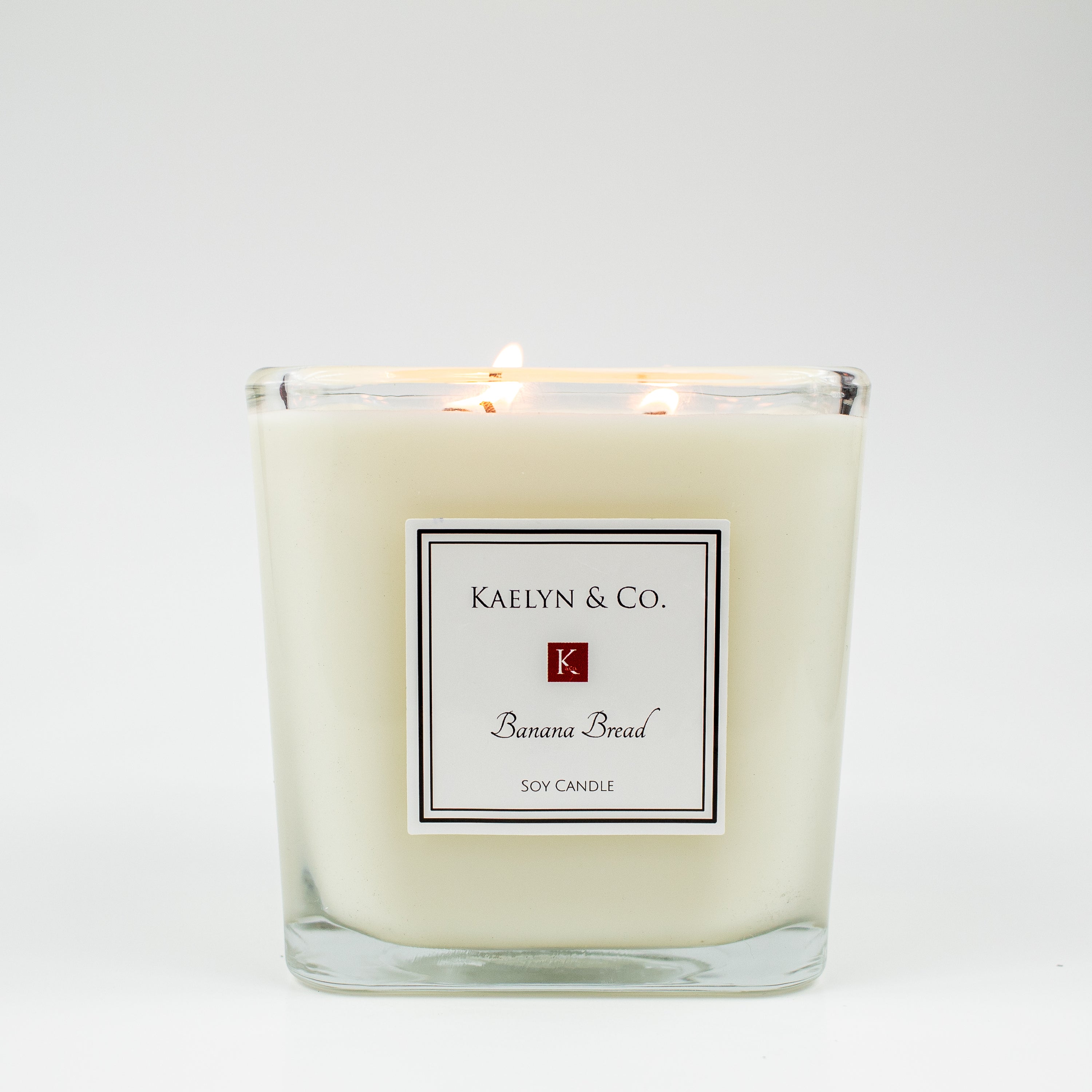 A large cube candle with a banana bread scent, featuring a warm, inviting design and triple wicks for an even burn.