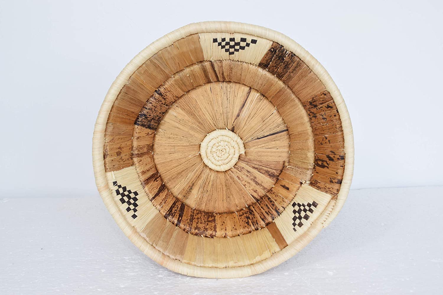 Beautifully woven banana fibre wall baskets in various colors, showcasing intricate designs and a natural aesthetic, perfect for home decor.