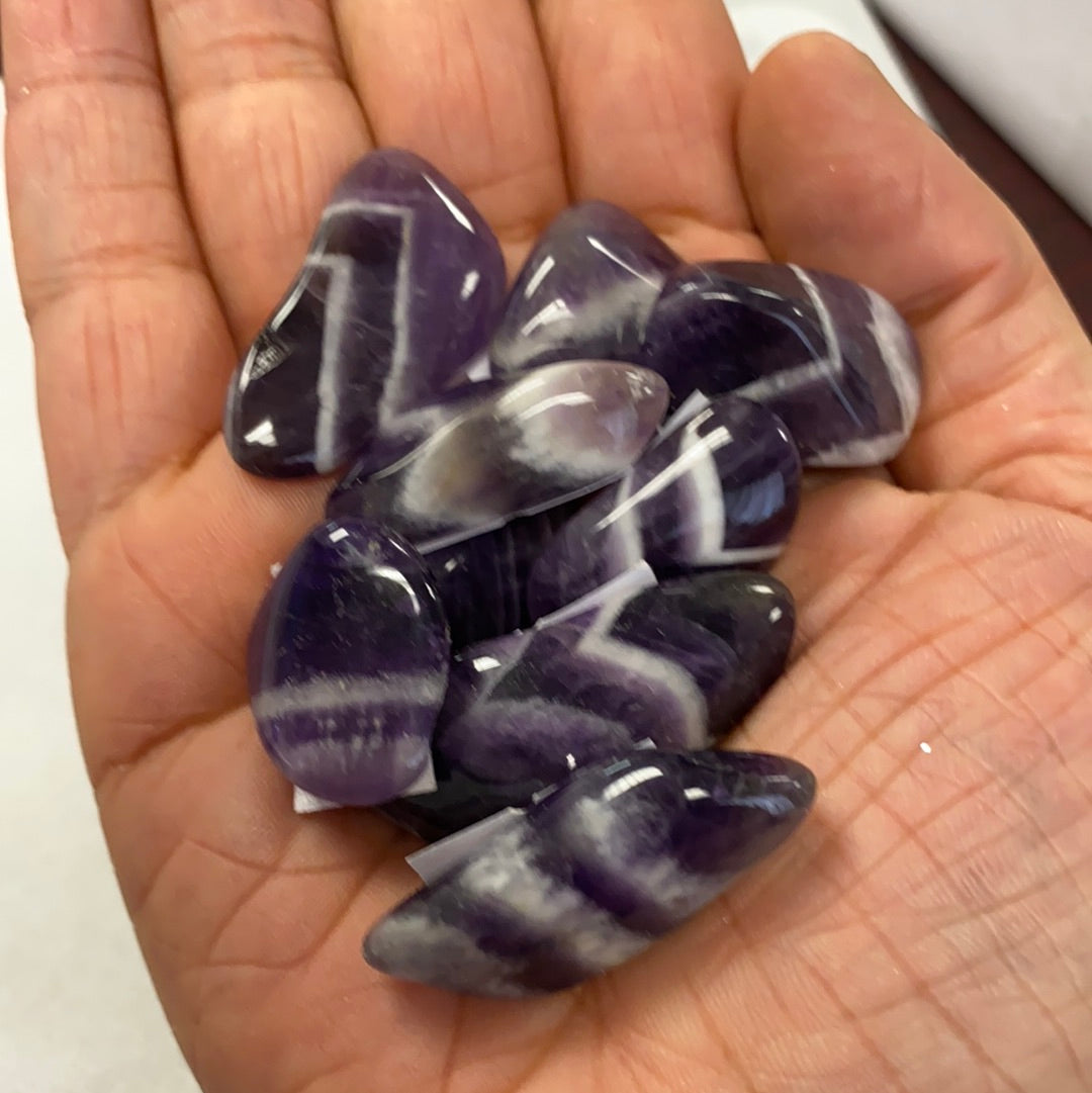 A collection of Banded Amethyst Tumbled Stones showcasing their unique purple hues and banding patterns, perfect for healing and meditation.
