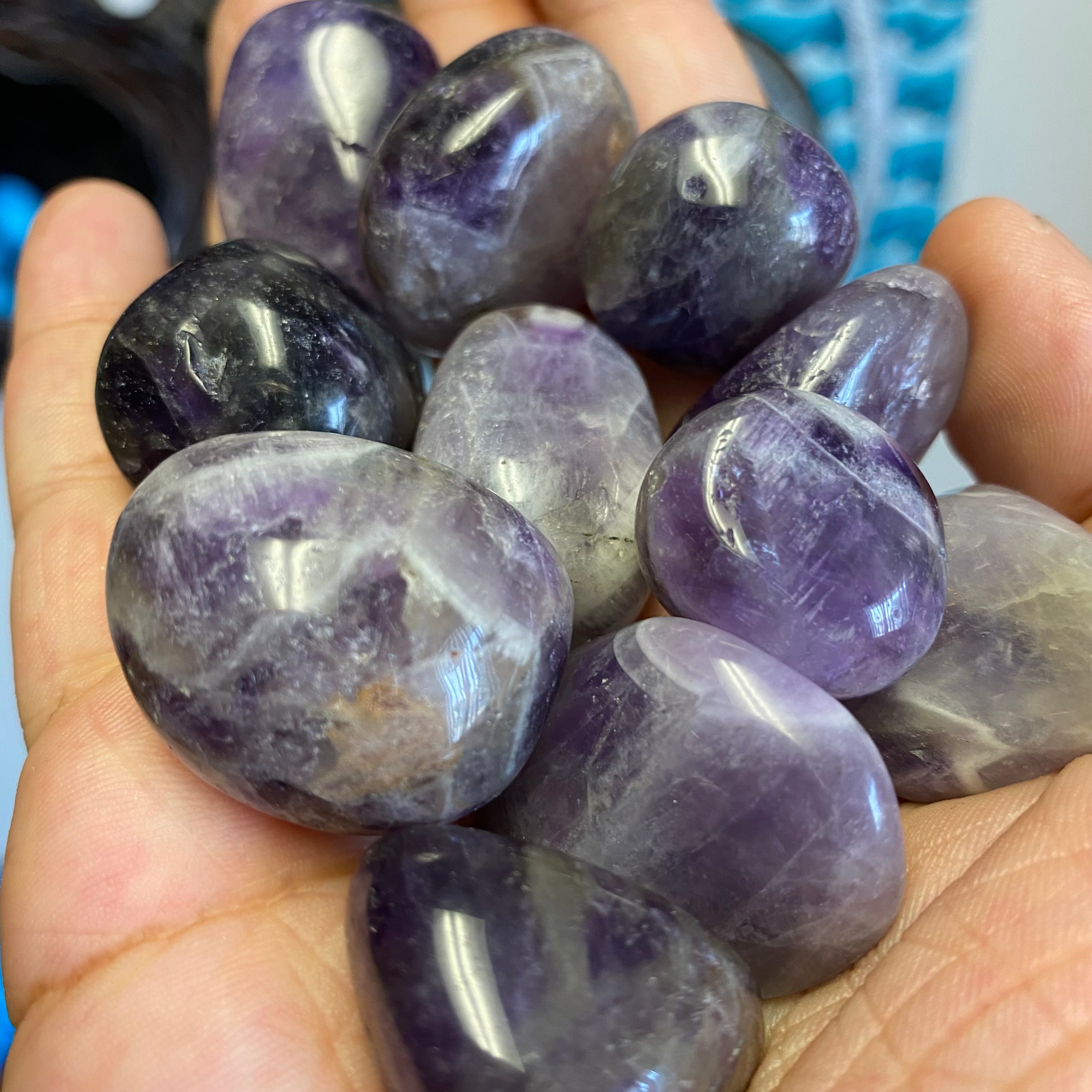 A collection of Banded Amethyst Tumbled Stones showcasing their unique purple hues and banding patterns, perfect for healing and meditation.