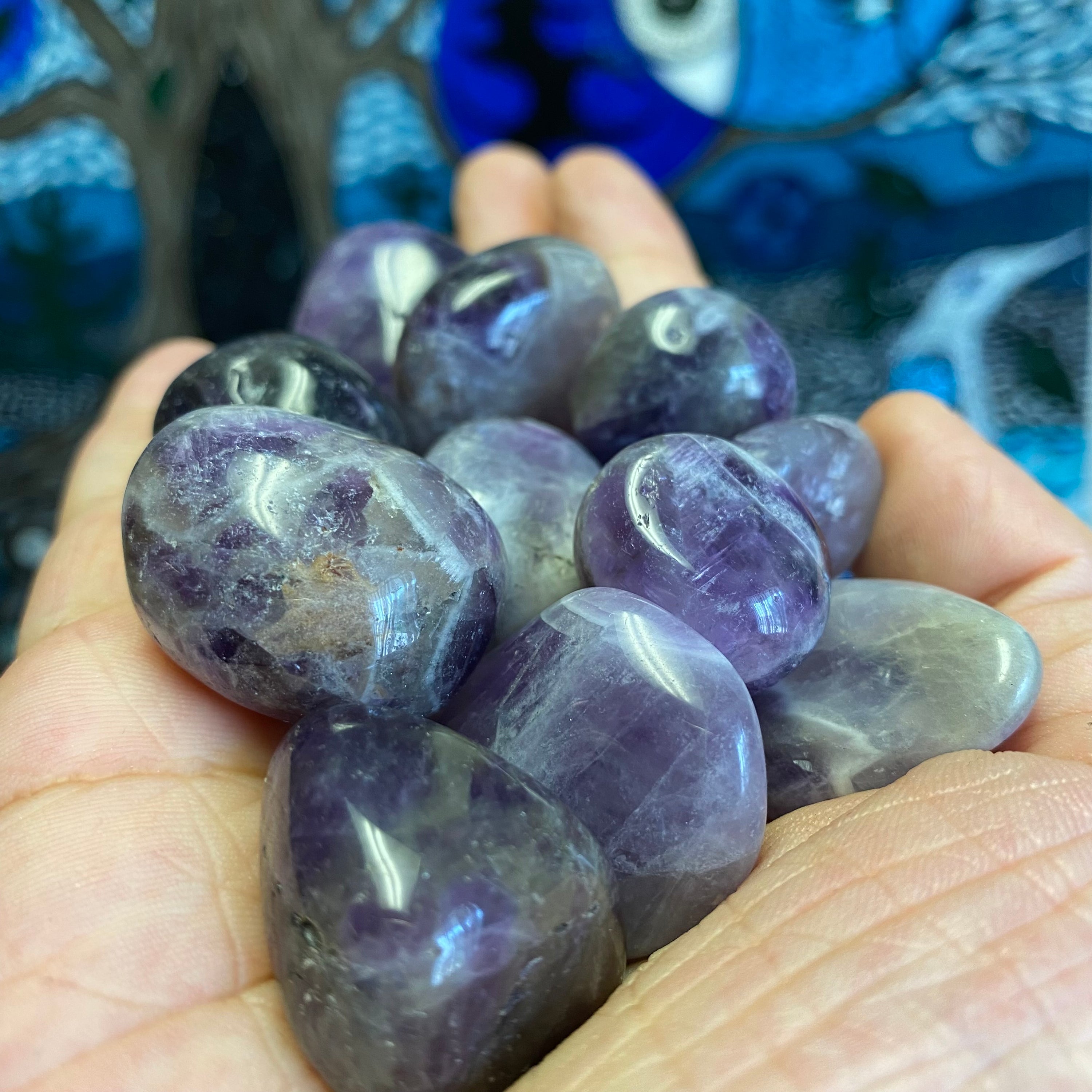 A collection of Banded Amethyst Tumbled Stones showcasing their unique purple hues and banding patterns, perfect for healing and meditation.