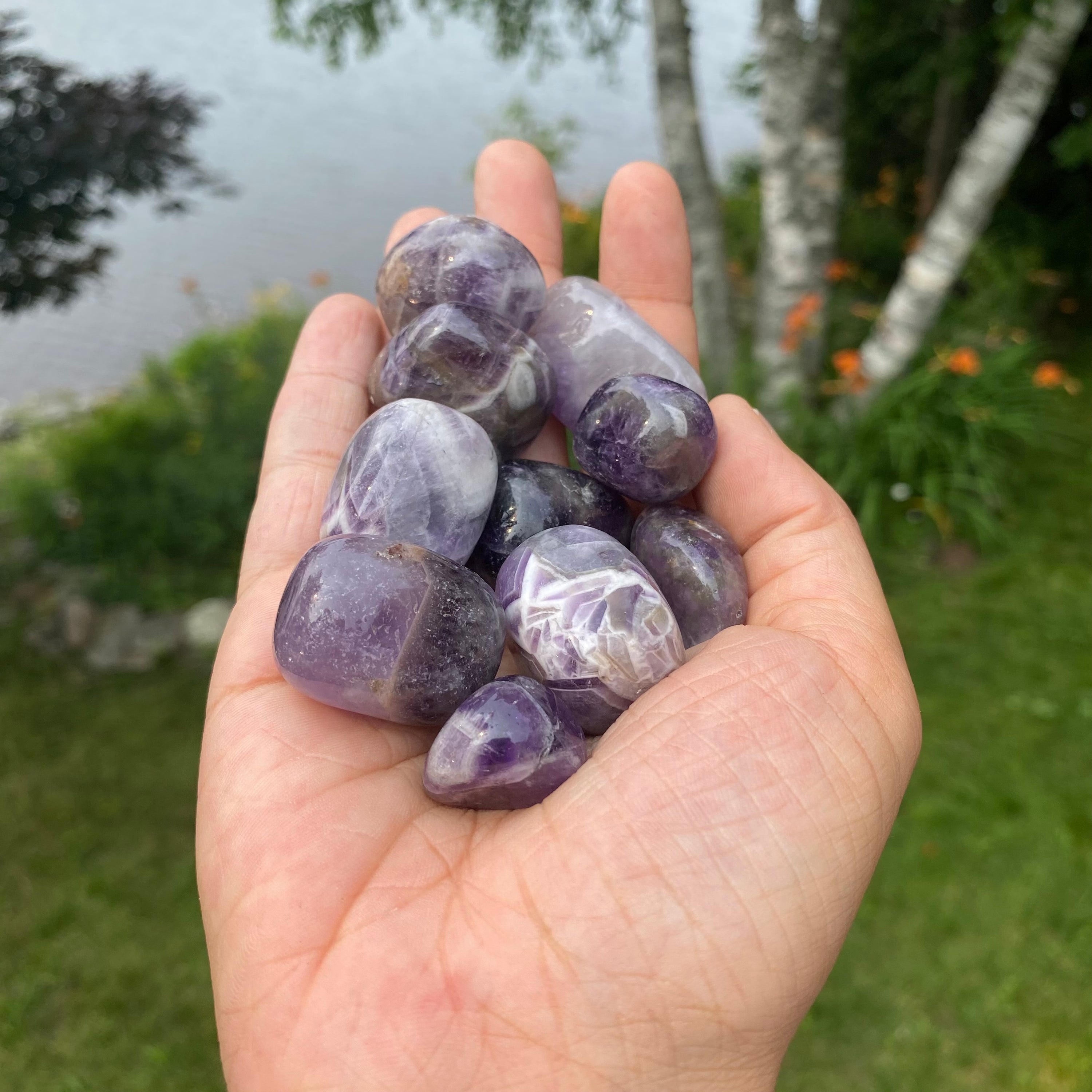 A collection of Banded Amethyst Tumbled Stones showcasing their unique purple hues and banding patterns, perfect for healing and meditation.