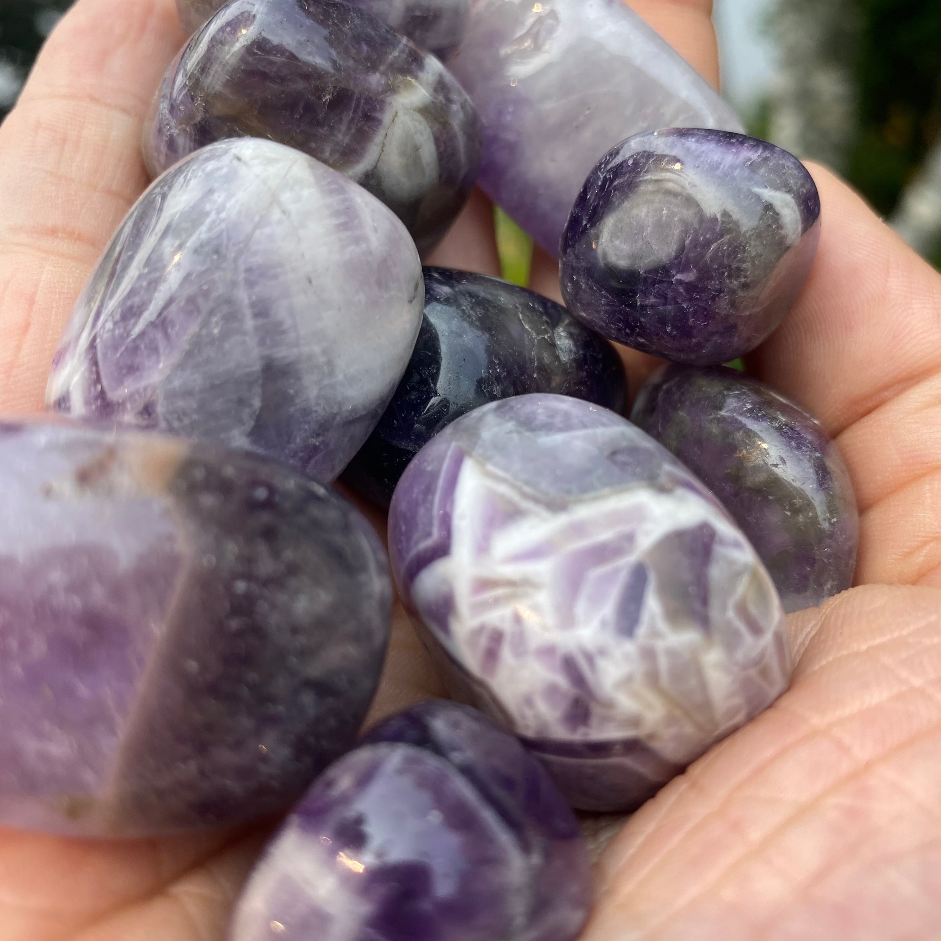A collection of Banded Amethyst Tumbled Stones showcasing their unique purple hues and banding patterns, perfect for healing and meditation.