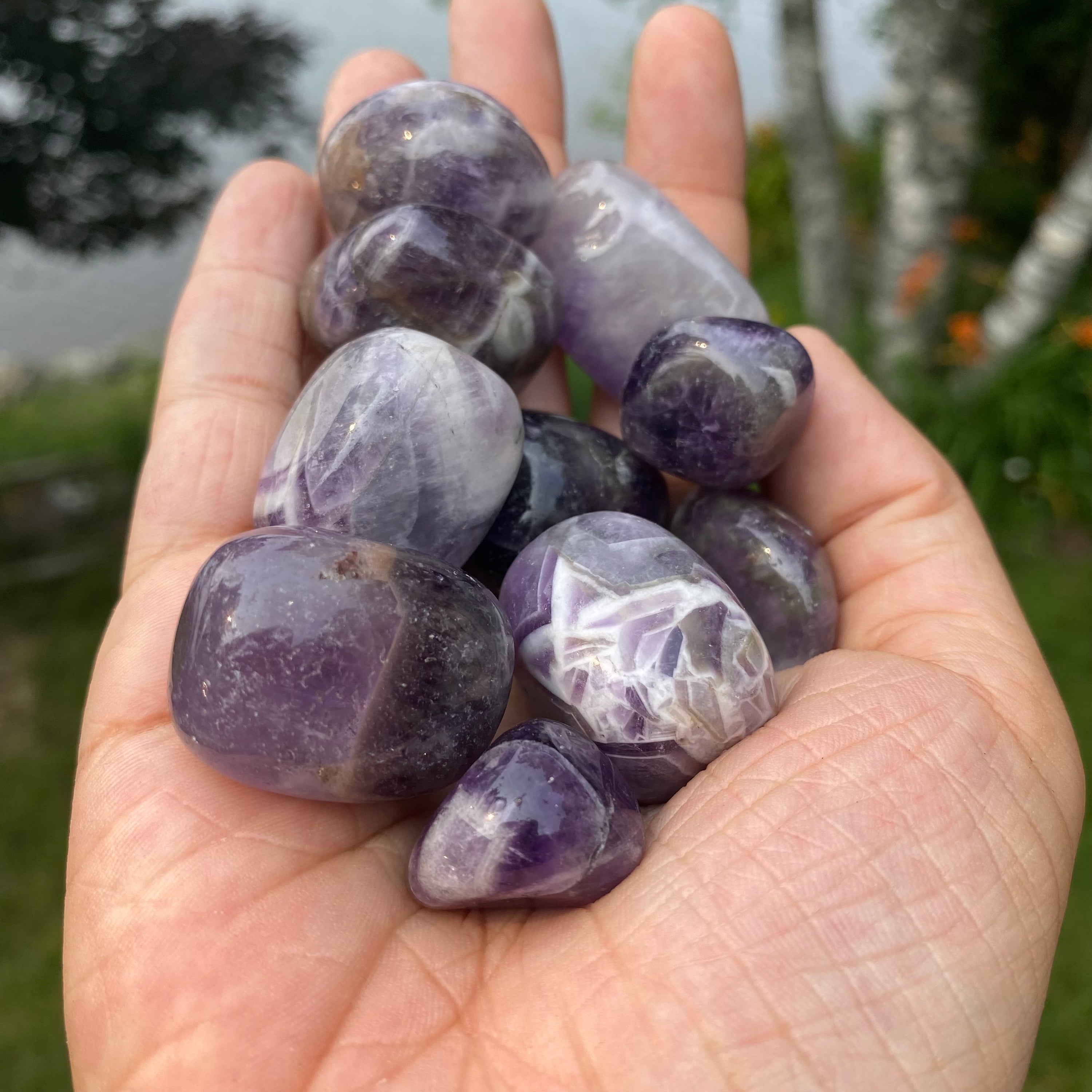 A collection of Banded Amethyst Tumbled Stones showcasing their unique purple hues and banding patterns, perfect for healing and meditation.