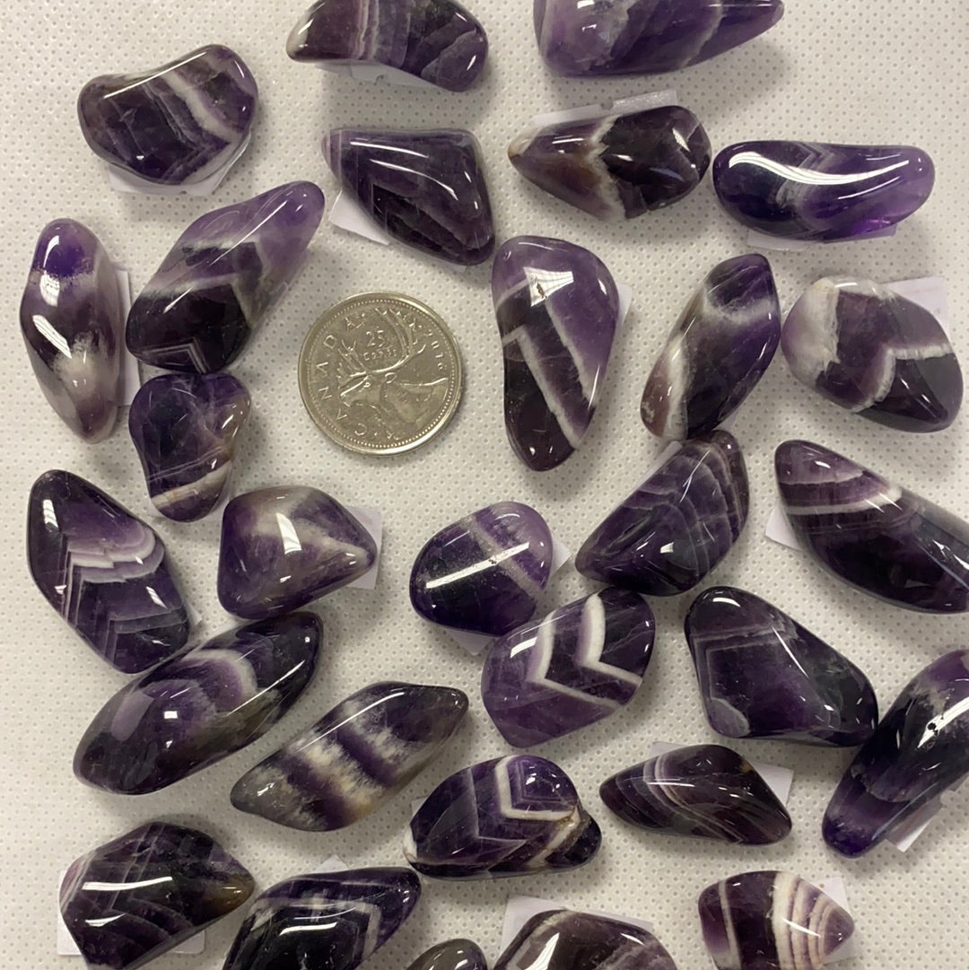 A collection of Banded Amethyst Tumbled Stones showcasing their unique purple hues and banding patterns, perfect for healing and meditation.