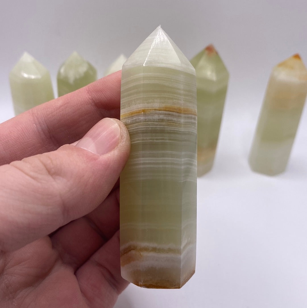 A 2.5-inch tall Banded Onyx Polished Point showcasing unique green and white bands.