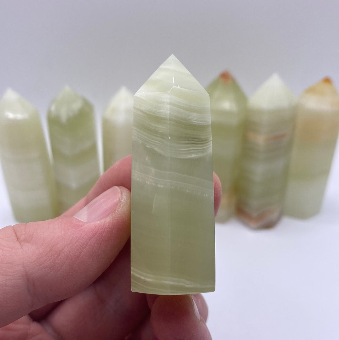 A 2.5-inch tall Banded Onyx Polished Point showcasing unique green and white bands.