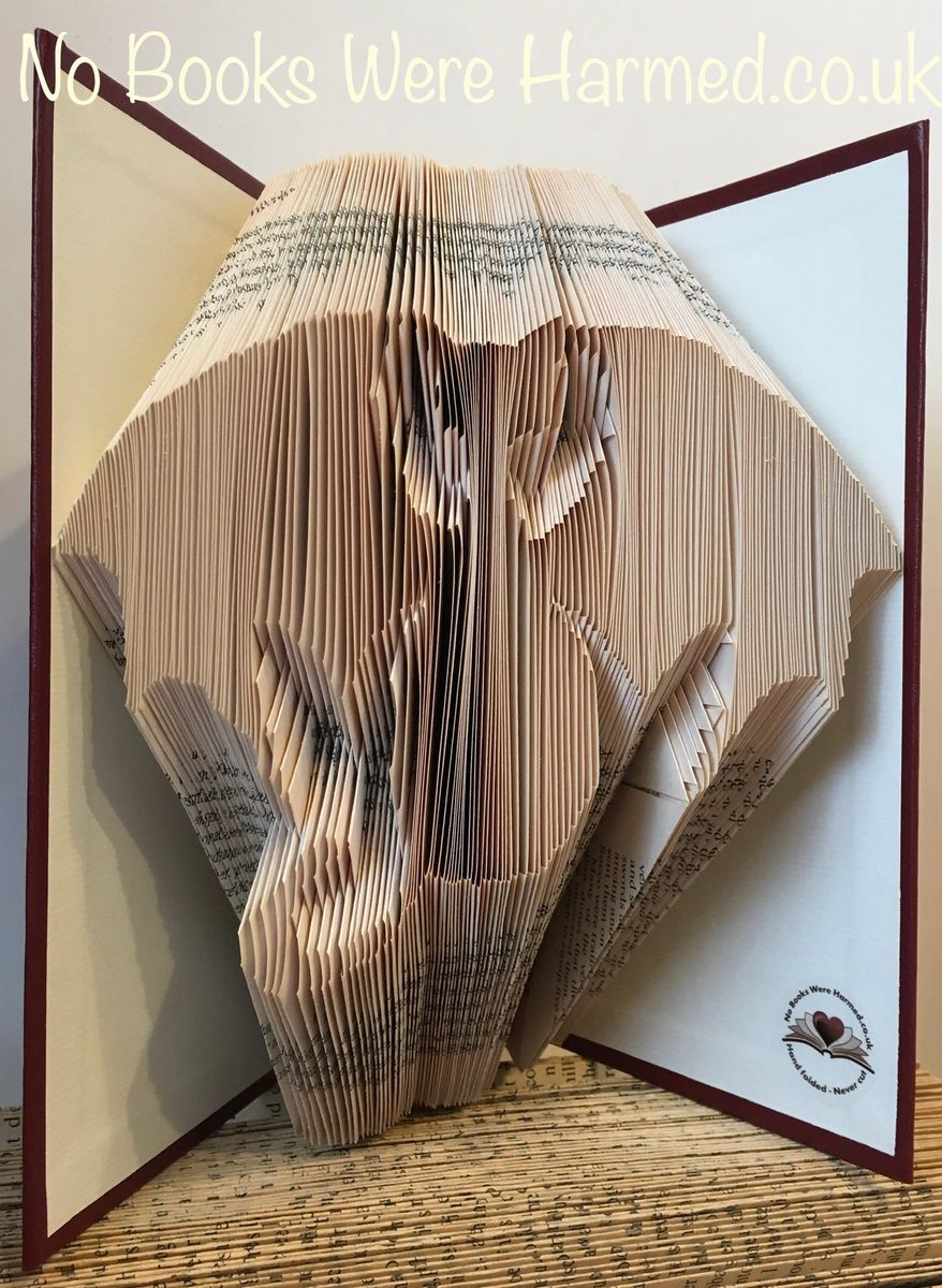 A handcrafted Bat Cat: Dragon Cat sculpture made from vintage book pages, showcasing intricate folds and unique design.