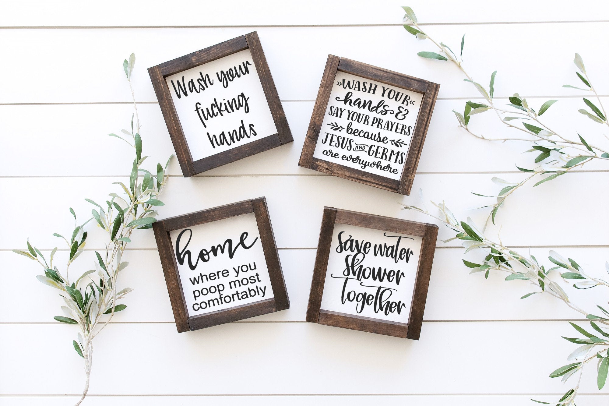 Handmade wooden bathroom sign with matte white finish, showcasing unique wood grain and knots.