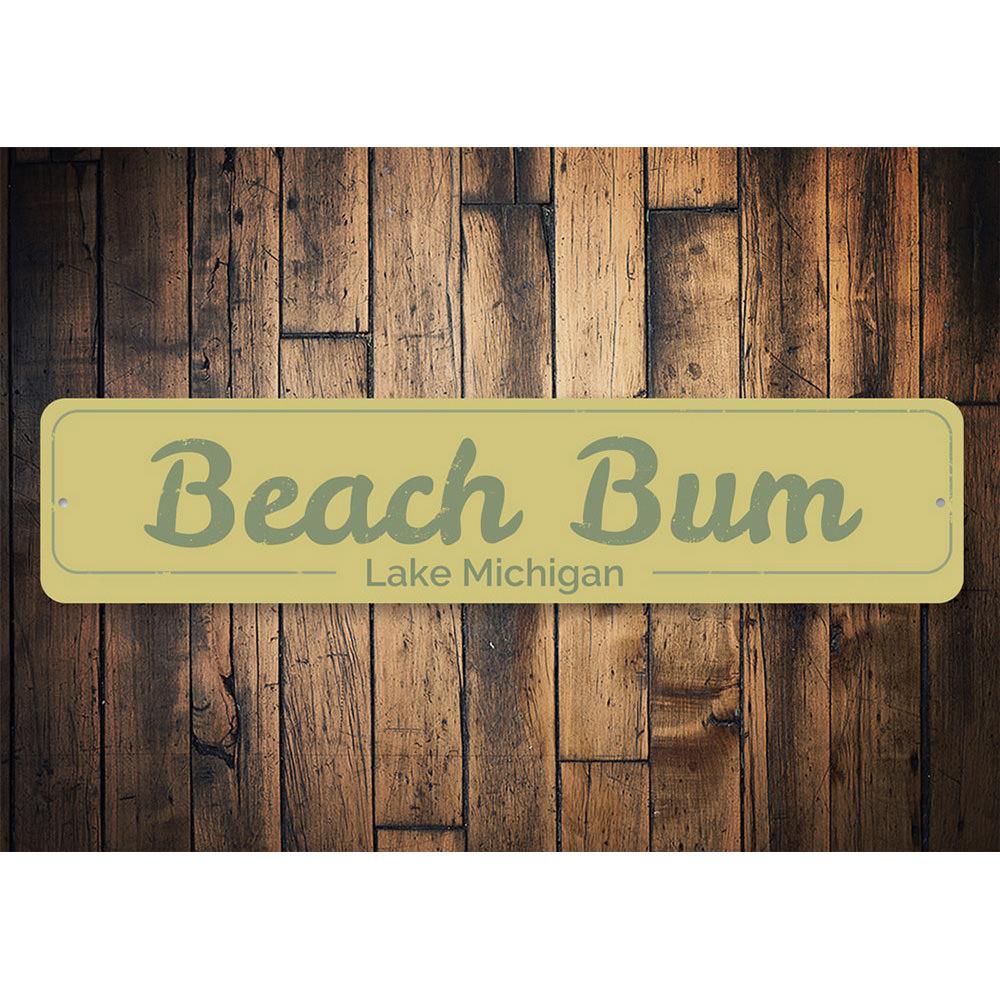 A decorative Beach Bum Sign made of high-quality aluminum, featuring a vibrant design perfect for lakeside cabins.