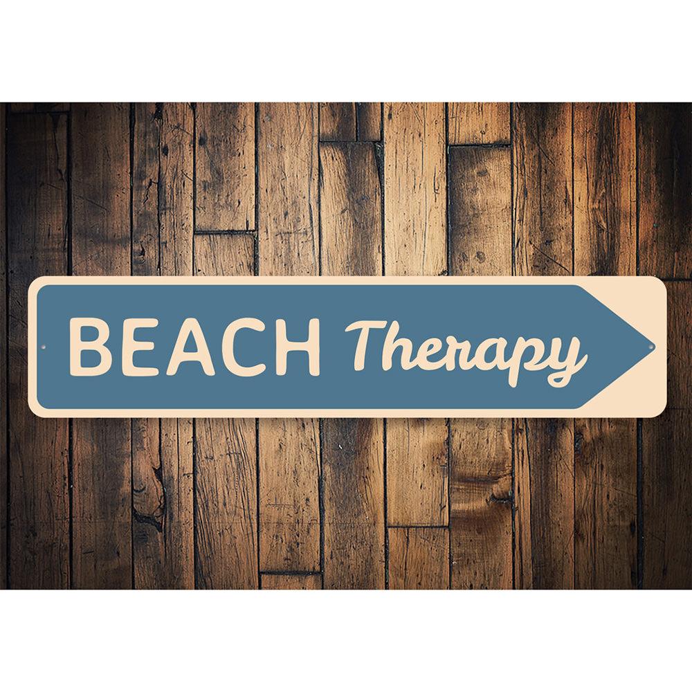 A decorative Beach Therapy Sign made of high-quality aluminum, featuring beach-themed graphics and customizable text, perfect for coastal decor.