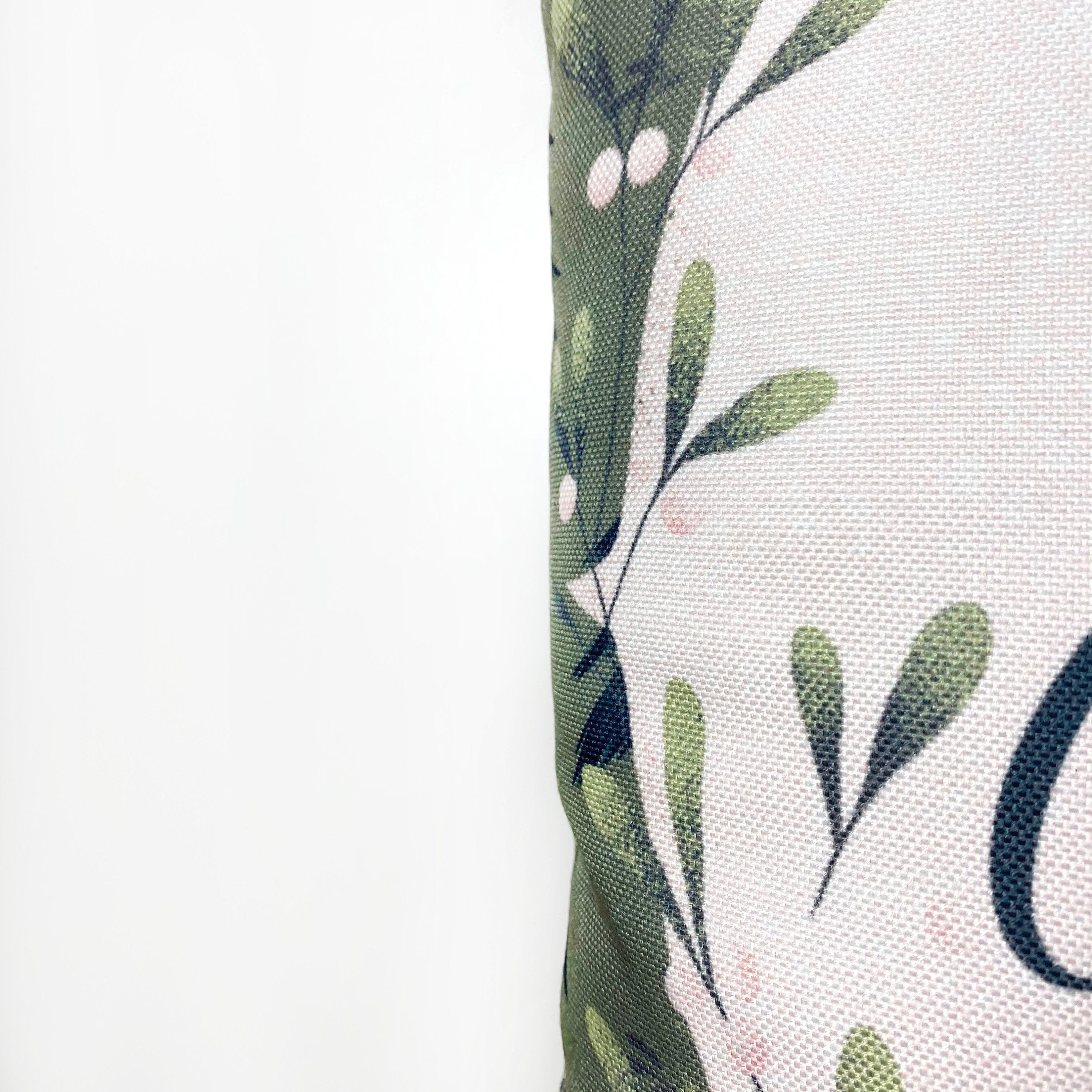 Beige Merry Christmas Throw Pillow Cover featuring a white circle with 'Merry Christmas' text, green wreath, and blue trees on a gray-green background.