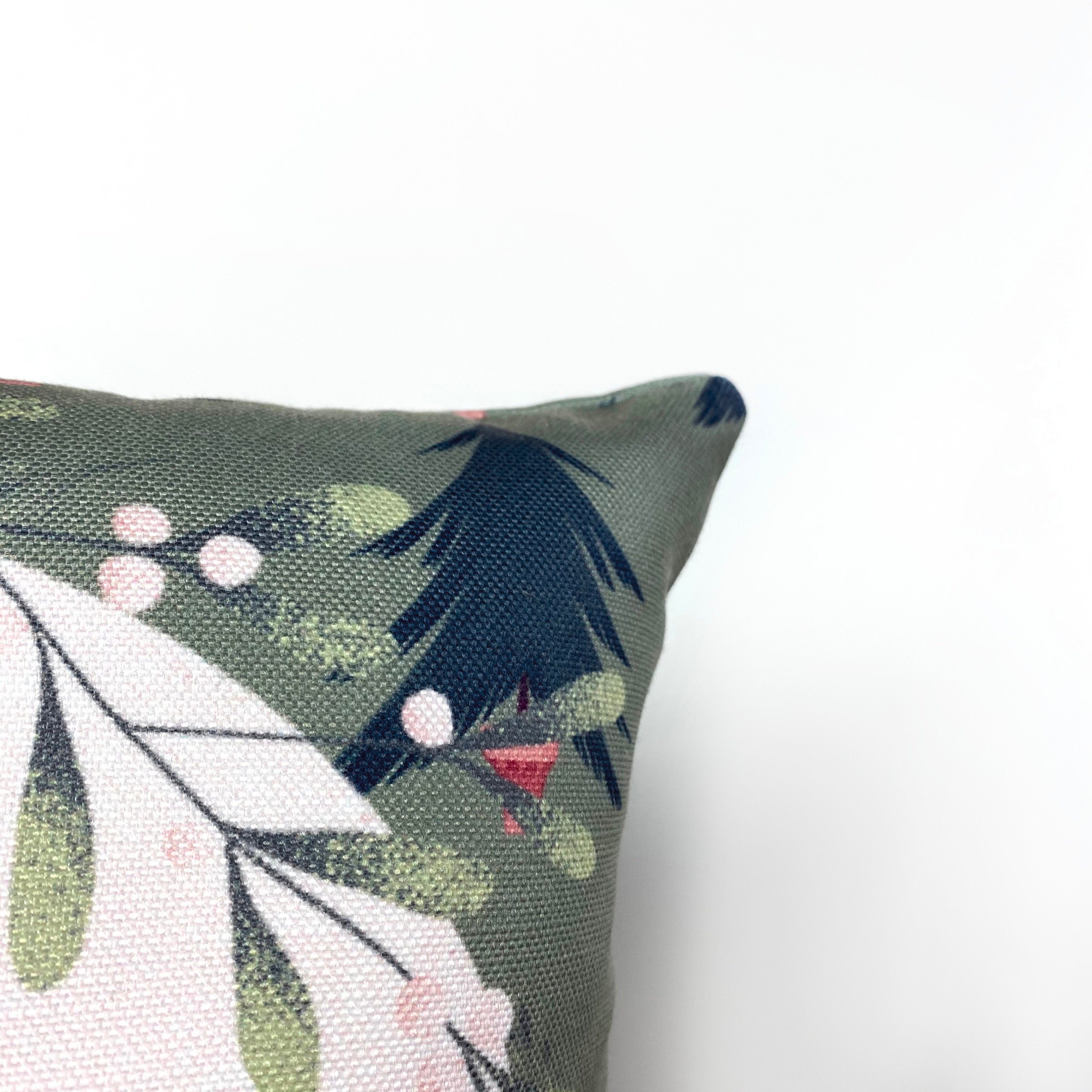 Beige Merry Christmas Throw Pillow Cover featuring a white circle with 'Merry Christmas' text, green wreath, and blue trees on a gray-green background.