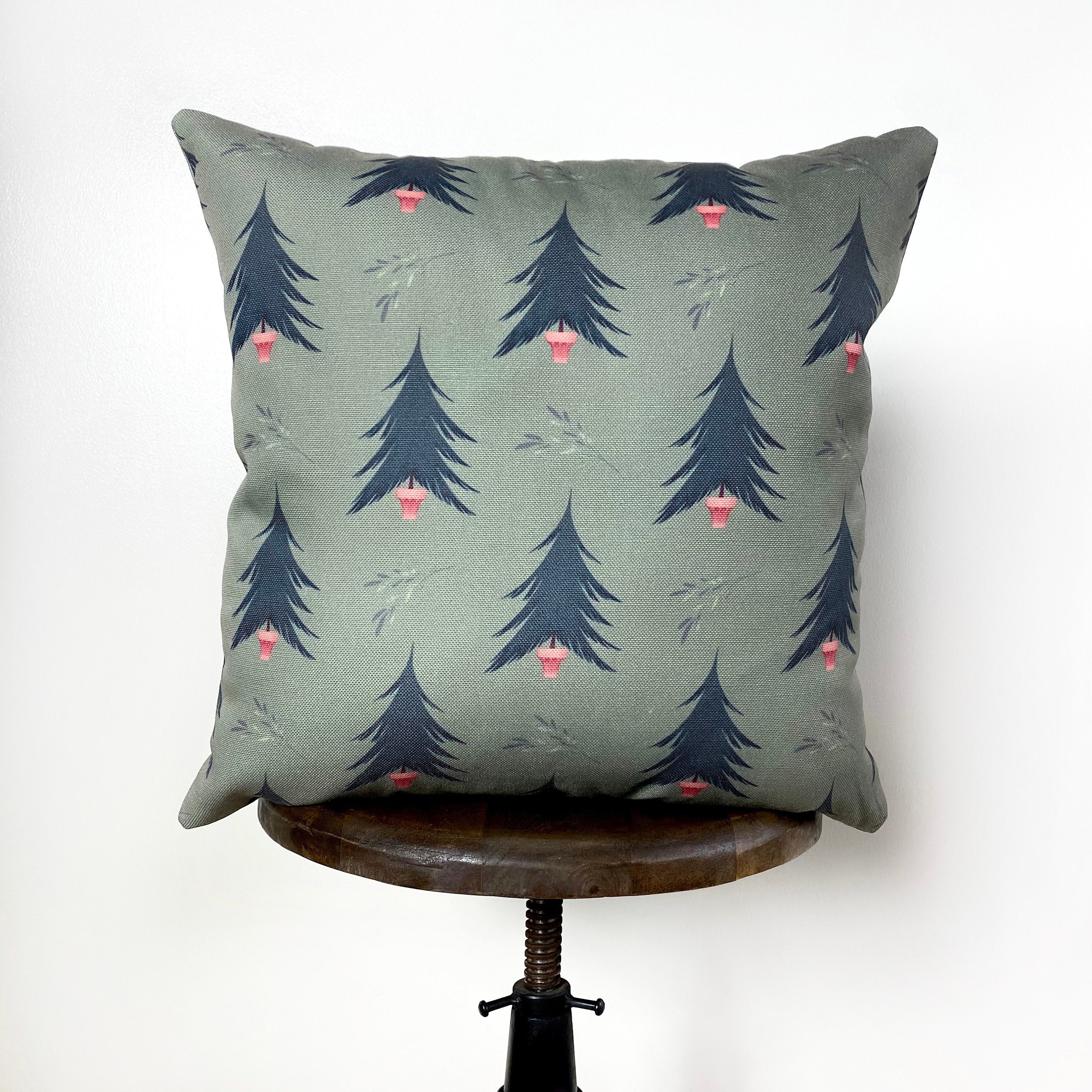 Beige Merry Christmas Throw Pillow Cover featuring a white circle with 'Merry Christmas' text, green wreath, and blue trees on a gray-green background.