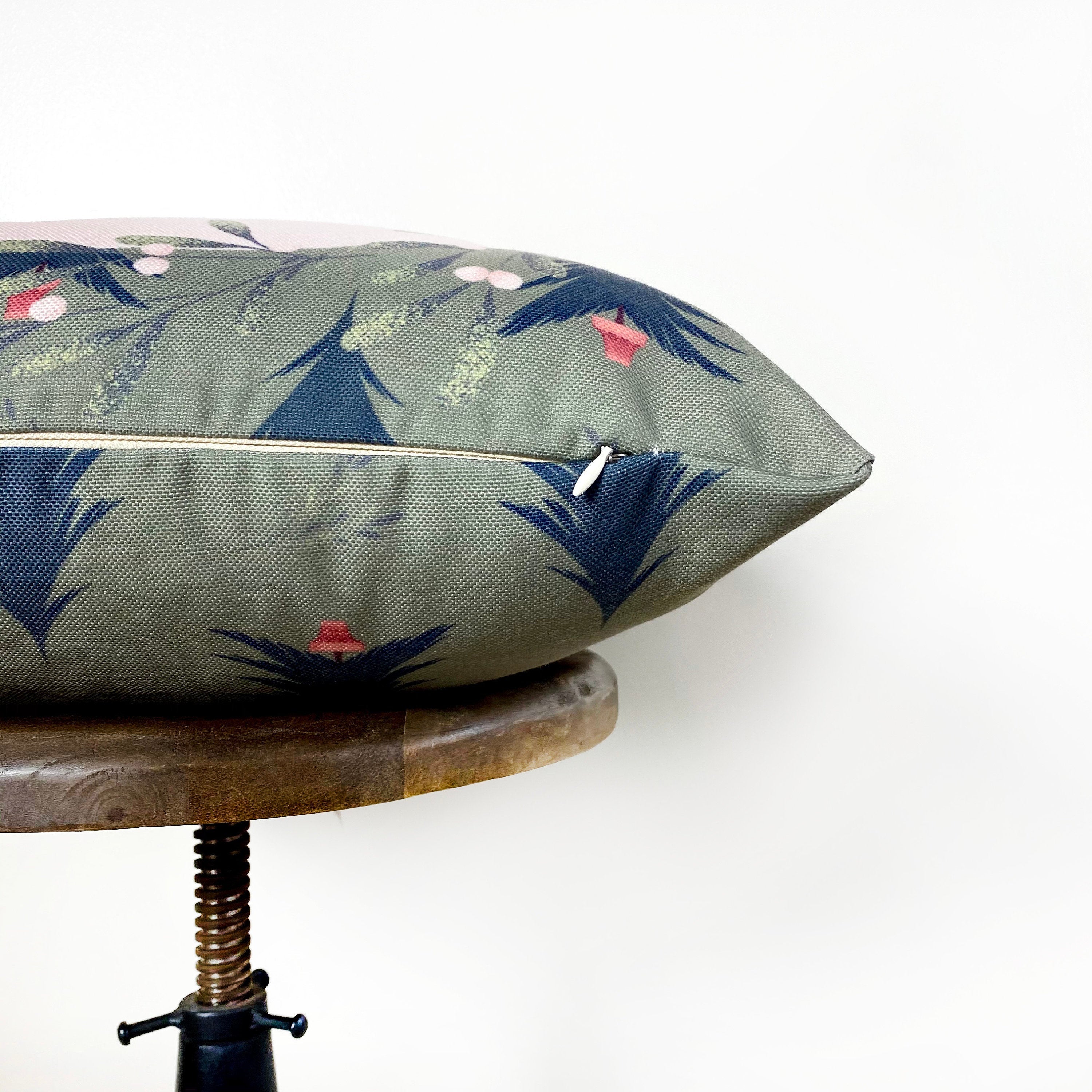 Beige Merry Christmas Throw Pillow Cover featuring a white circle with 'Merry Christmas' text, green wreath, and blue trees on a gray-green background.