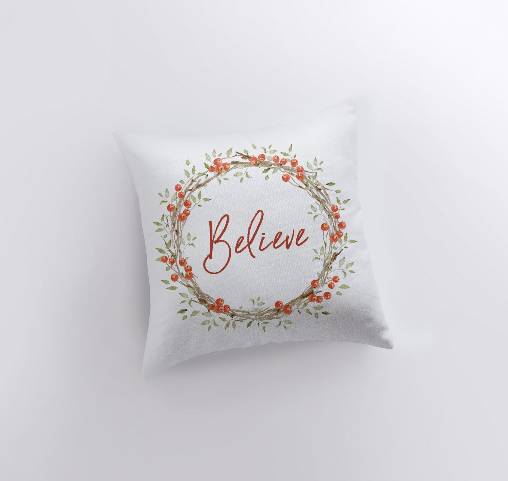 Believe with Berry Wreath Christmas Throw Pillow featuring red text and holly berry wreath on a white background, perfect for holiday decor.