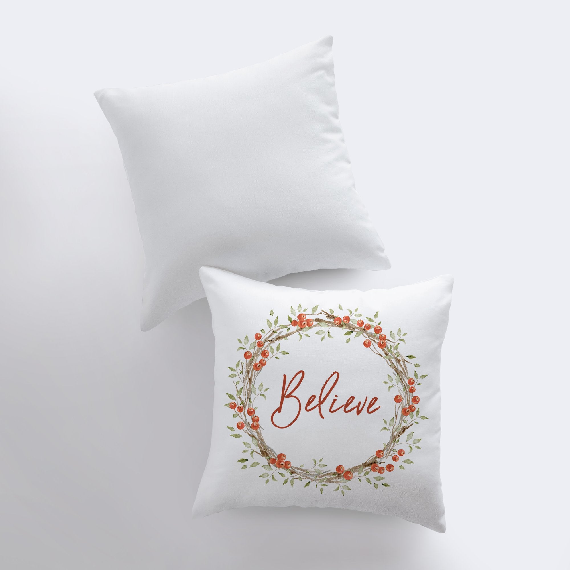 Believe with Berry Wreath Christmas Throw Pillow featuring red text and holly berry wreath on a white background, perfect for holiday decor.