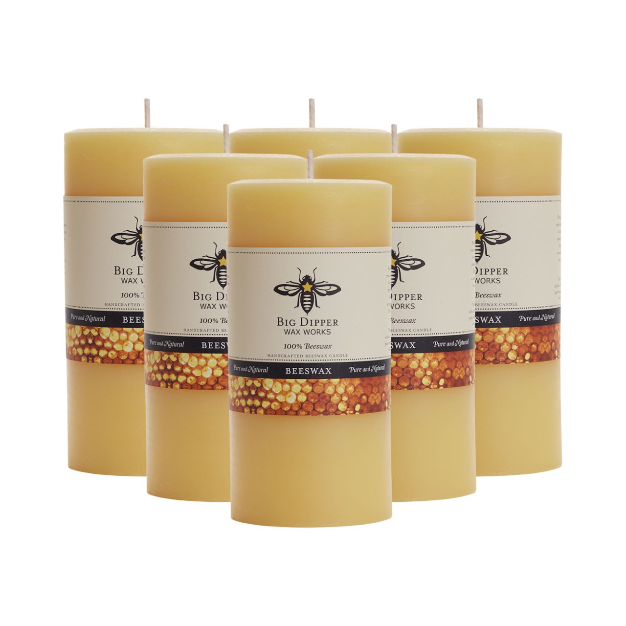 Big Dipper Wax Works All Hallows Eve Beeswax Pillars in natural and ivory colors, showcasing their elegant design and warm glow.
