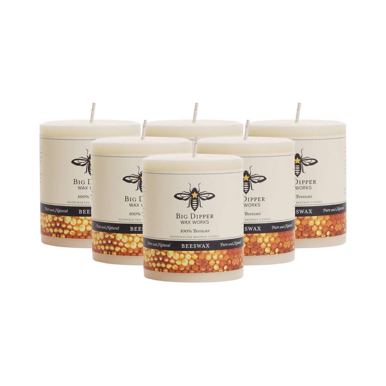 Big Dipper Wax Works All Hallows Eve Beeswax Pillars in natural and ivory colors, showcasing their elegant design and warm glow.