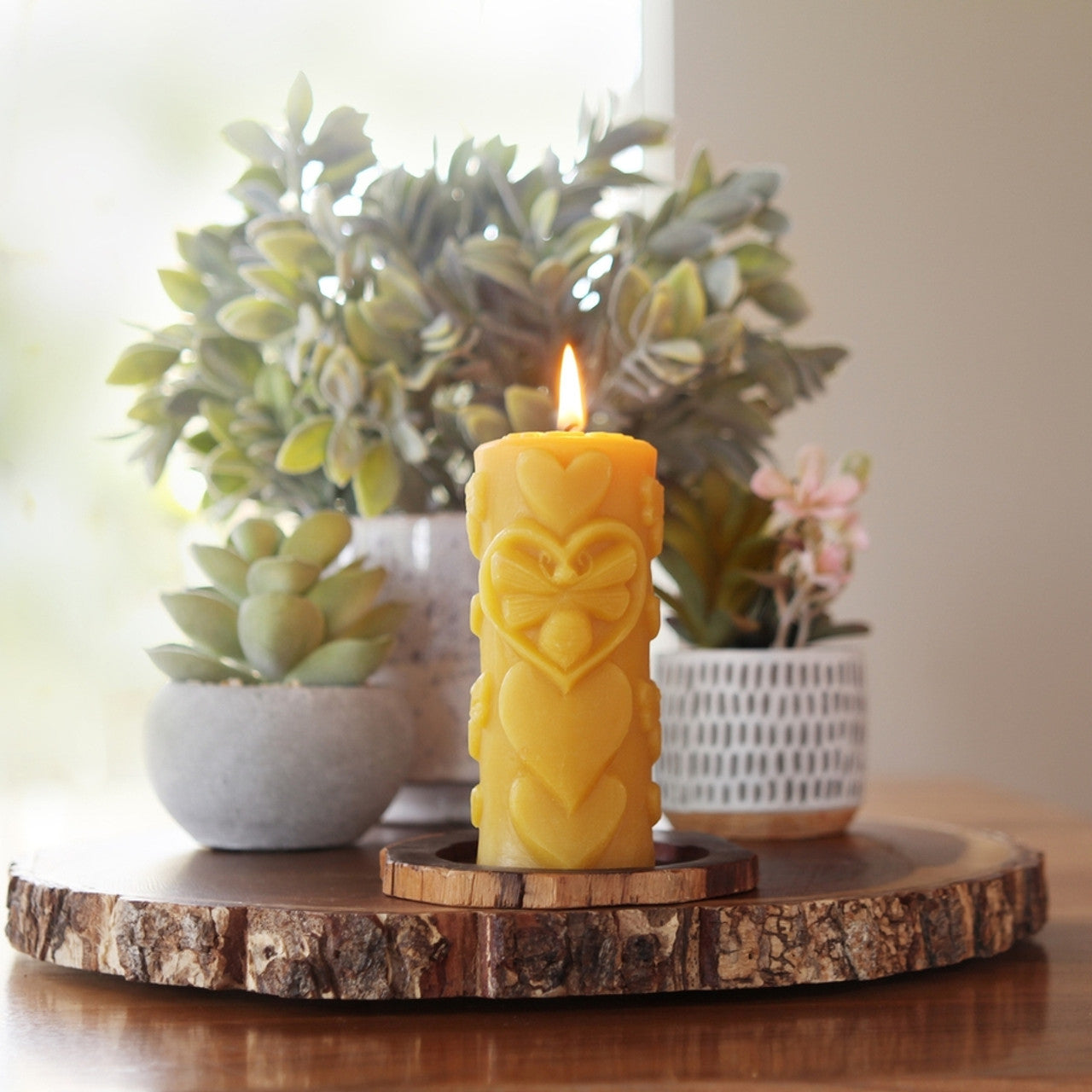 Big Dipper Wax Works Bee-Love Pillar candle, hand sculpted with a bee-in-heart design, made from 100% pure beeswax.