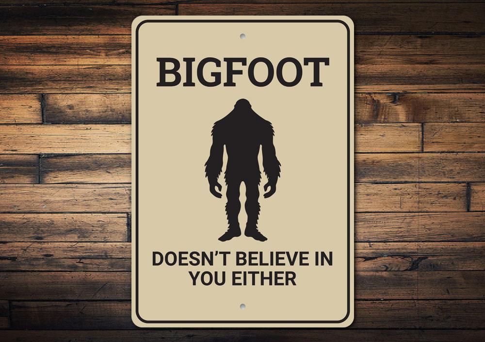 Bigfoot Doesn't Believe in You decorative sign made of aluminum, featuring humorous text and designed for wall mounting.