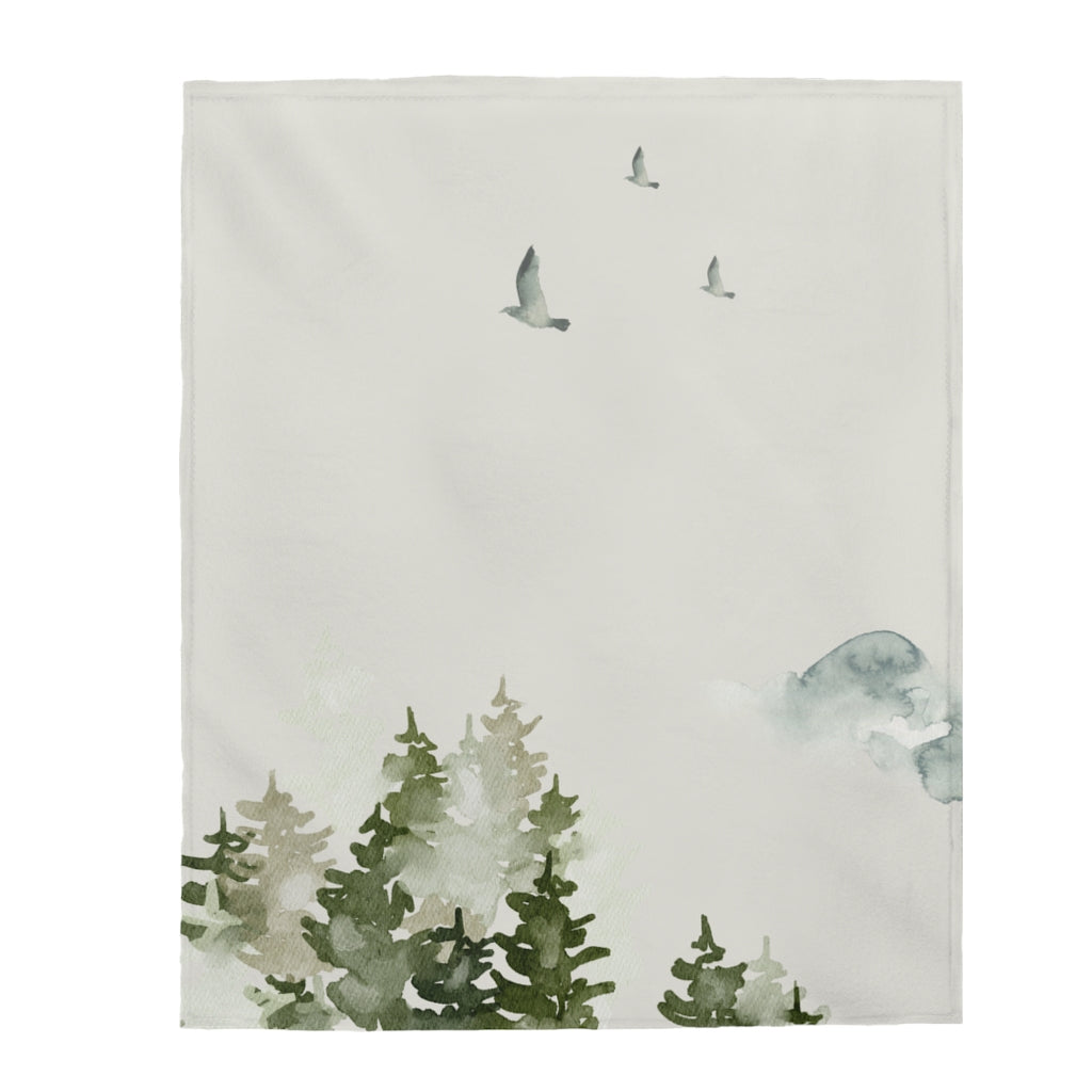 A plush throw blanket featuring a beautiful birds over forest design, showcasing vibrant colors and soft velveteen texture, perfect for cozying up at home.