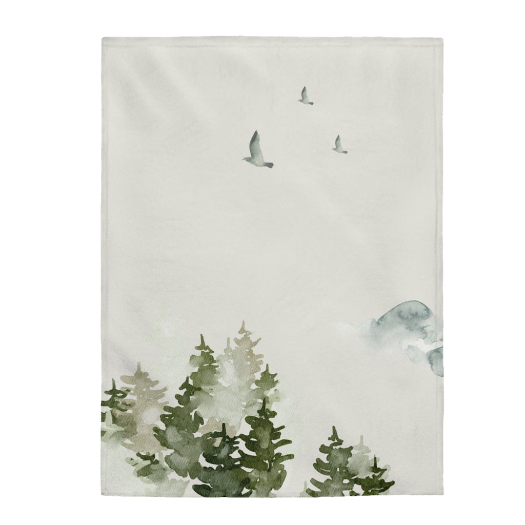 A plush throw blanket featuring a beautiful birds over forest design, showcasing vibrant colors and soft velveteen texture, perfect for cozying up at home.