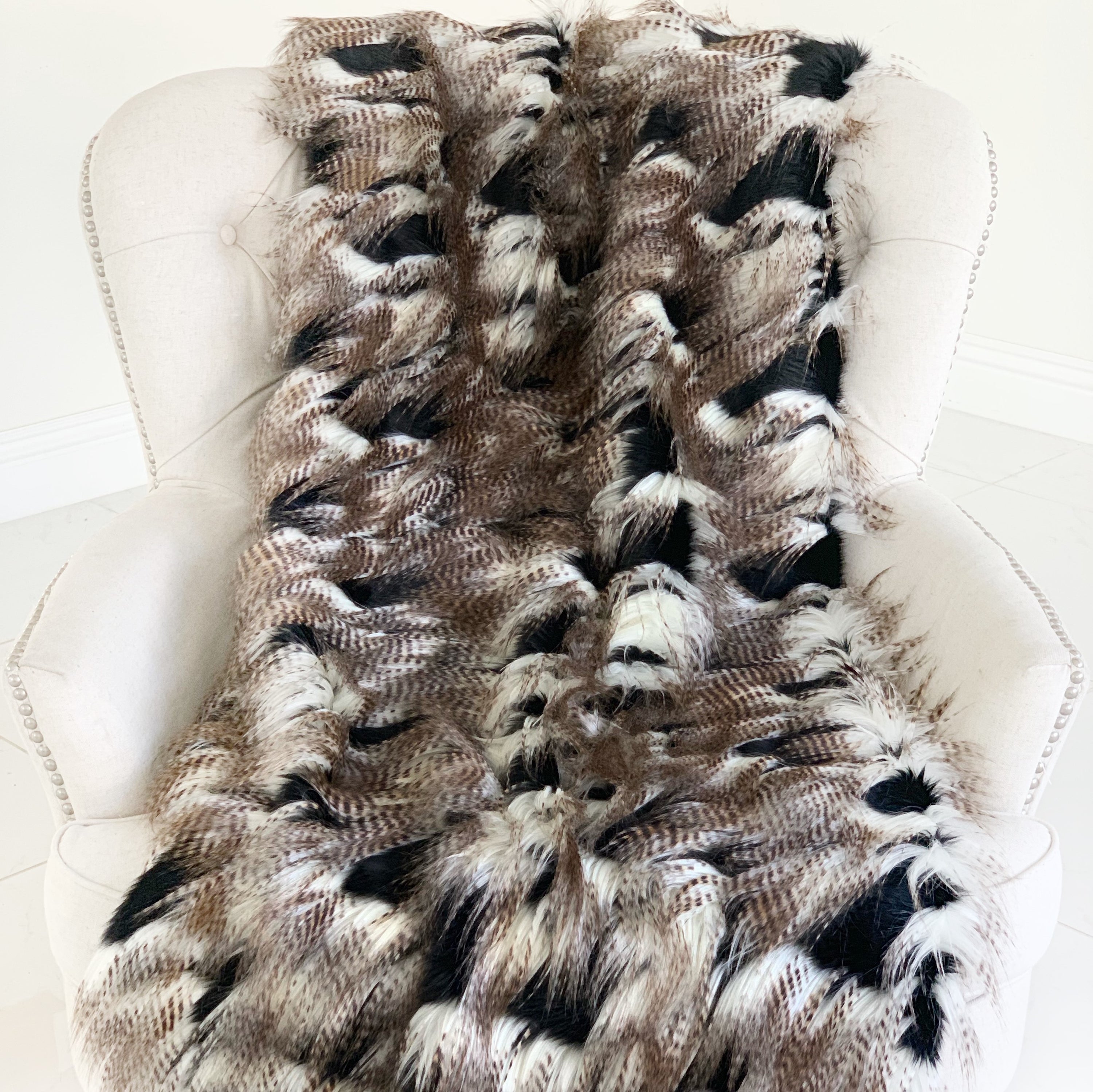 Luxurious black and gold rococo plush throw blanket, handmade with faux fur, showcasing intricate design and reversible feature.